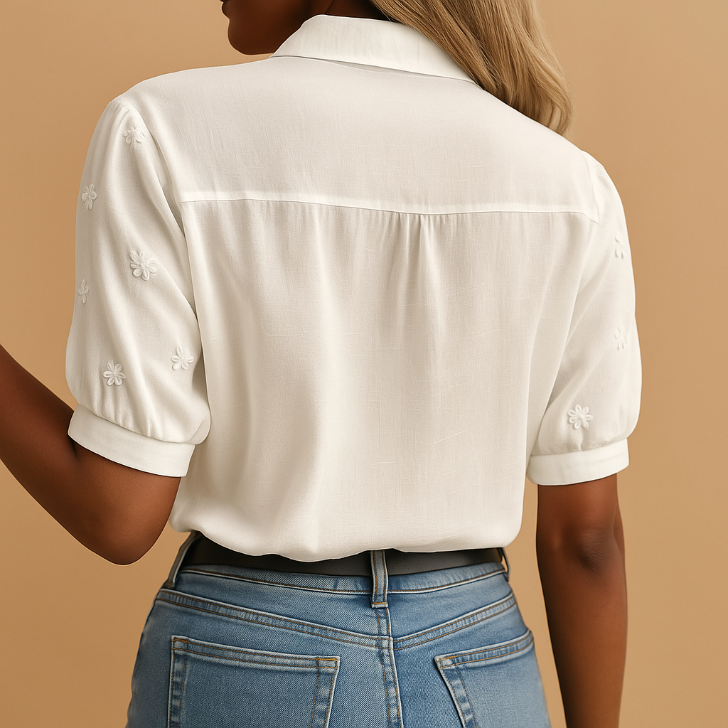 White elegant blouse for women with a classic collar and button closure, perfect for work, casual wear, and evening outings.